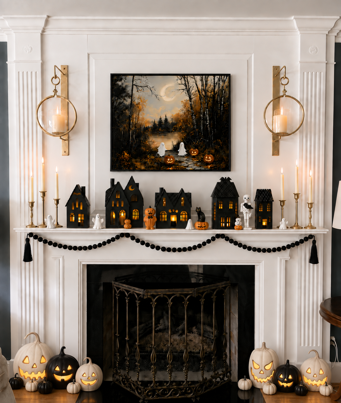 Miniature black haunted houses with glowing windows, tiny ghosts, and pumpkin lights on a mantel